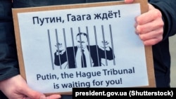 Плякат падчас акцыі насупраць сядзібы Міжнароднага суду ААН у Гаазе 