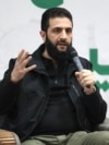 (FILES) -- Abu Mohamed al-Jolani, who heads the Islamist group Hayat Tahrir al-Sham (HTS), speaks during a press conference in the area of Bab al-Hawa crossing in northern Syria on March 12, 2024.