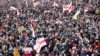 BELARUS – Opposition supporters carrying former white-red-white flags of Belarus parade through the streets during a rally to protest against the Belarus presidential election results in Minsk on October 18, 2020